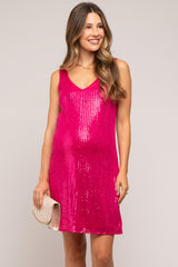 woman wearing a hot pink sequin maternity dress with a v-neck and holding a clutch, baby bump visible