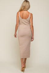 woman wearing a fitted ribbed maternity dress in beige, showcasing a back view with a midi length