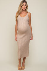 woman wearing a nude ribbed maternity dress that accentuates her baby bump