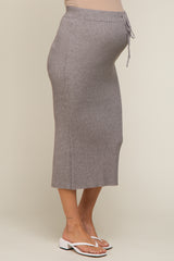 woman wearing a grey ribbed maternity midi skirt with a drawstring waist and a visible baby bump