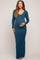 woman wearing a teal long sleeve maternity dress with a fitted silhouette and holding her baby bump