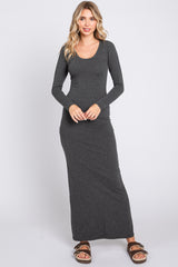 woman wearing a charcoal gray long sleeve maxi dress standing and smiling