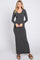 woman wearing a charcoal gray long sleeve maxi dress standing and smiling