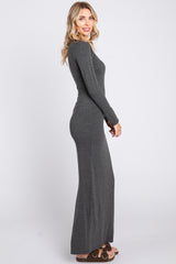 woman wearing a fitted gray long sleeve maxi dress styled with brown sandals