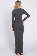 woman wearing a gray long sleeve maxi dress with a slit at the back