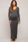 woman wearing a dark gray long sleeve maternity dress with a fitted silhouette and visible baby bump