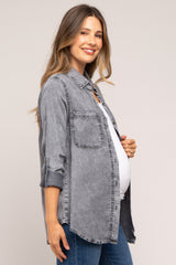 woman wearing a grey denim maternity shirt with rolled sleeves and a visible baby bump