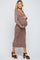 woman wearing a brown ribbed knit maternity dress with a fitted silhouette and holding her baby bump