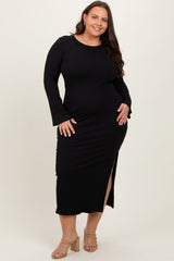 woman wearing a black ribbed long sleeve plus size dress with a side slit and bell sleeves