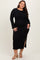 woman wearing a black ribbed long sleeve plus size dress with a side slit and bell sleeves