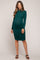 woman wearing a dark green long sleeve maternity dress with ruching and a visible baby bump