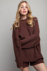 woman wearing a burgundy oversized knitted sweater with long sleeves and matching shorts