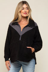 woman wearing a black and gray zip-up fleece maternity pullover with a front pocket