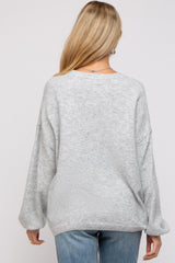 woman wearing a grey maternity oversized sweater with dropped shoulders and back view displayed