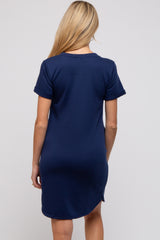woman wearing a navy blue short sleeve maternity dress seen from the back