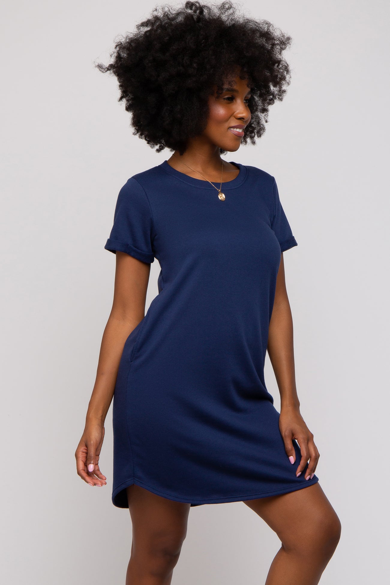 woman wearing a navy blue short sleeve t-shirt dress with a relaxed fit and side slits