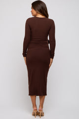 woman wearing a brown long sleeve maternity dress with a fitted waist and midi length from the back