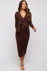 woman wearing a brown long sleeve maternity wrap dress with a tie at the waist and a visible baby bump