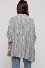woman wearing a black and white striped maternity top with a loose, flowy fit, viewed from the back