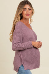 woman wearing a light purple maternity sweater with a v-neck and side slits, showing her baby bump