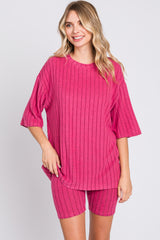 woman wearing a pink ribbed oversized t-shirt and matching bike shorts