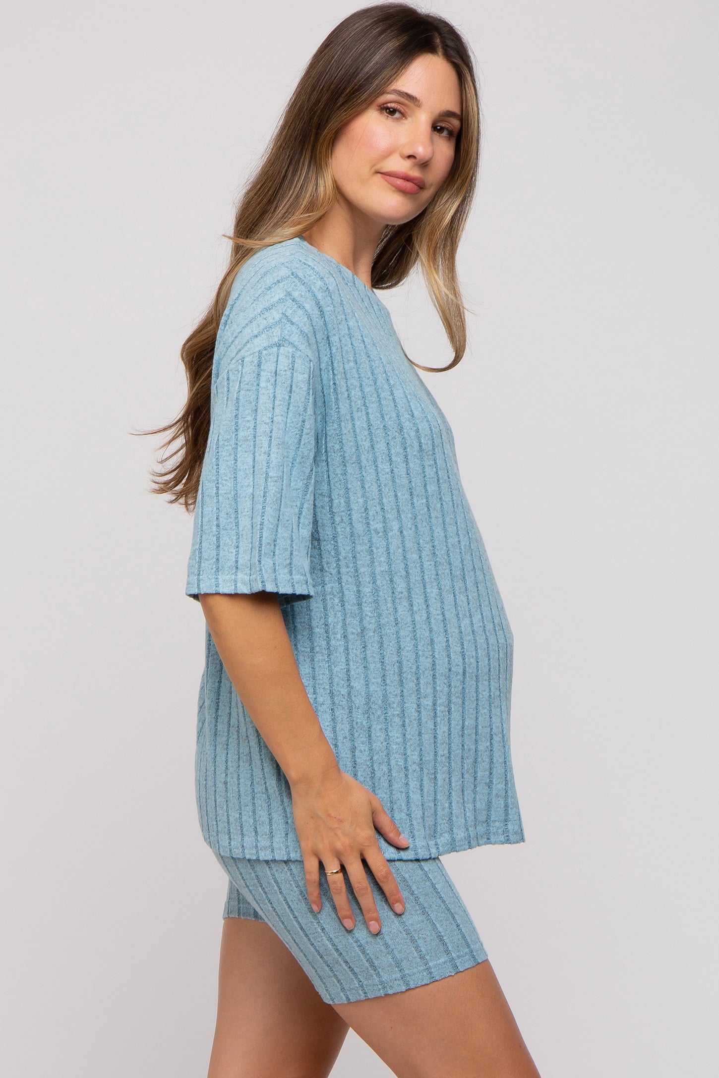 woman wearing a light blue ribbed maternity lounge set with a relaxed fit and visible baby bump
