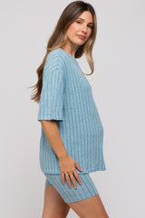 woman wearing a light blue ribbed maternity lounge set with a relaxed fit and visible baby bump