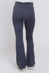 woman wearing gray maternity activewear pants with a flared hem, showing the back view
