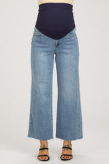 maternity wear high-waisted wide-leg jeans in light blue with a navy belly band, model wearing them with open-toed sandals