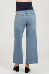 woman wearing light blue maternity wide-leg jeans with a frayed hem, shown from the back