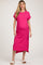 woman wearing a bright pink ribbed maternity dress with short sleeves and a side slit, showcasing her baby bump