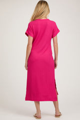 woman wearing a bright pink maternity maxi dress with short sleeves and side slits