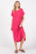 woman wearing a bright pink short sleeve midi dress with side slits and a relaxed fit