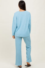 woman wearing a light blue ribbed lounge set with a relaxed fit top and matching wide-leg pants