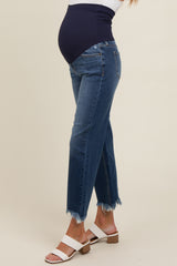 woman wearing dark blue maternity jeans with a frayed hem and a supportive over-the-bump waistband, showing her baby bump