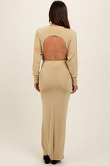 woman wearing a beige long sleeve maternity dress with an open back, showcasing the fit and design