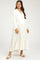 woman wearing a cream maternity maxi dress with a button-up front and tiered ruffle accents, showcasing her baby bump
