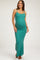 woman wearing a teal ribbed maternity maxi dress and gently cradling her baby bump