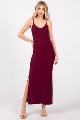woman wearing a burgundy ribbed maxi dress with a side slit and spaghetti straps
