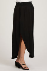 woman wearing a black maternity maxi skirt with a side slit and an elastic waistband
