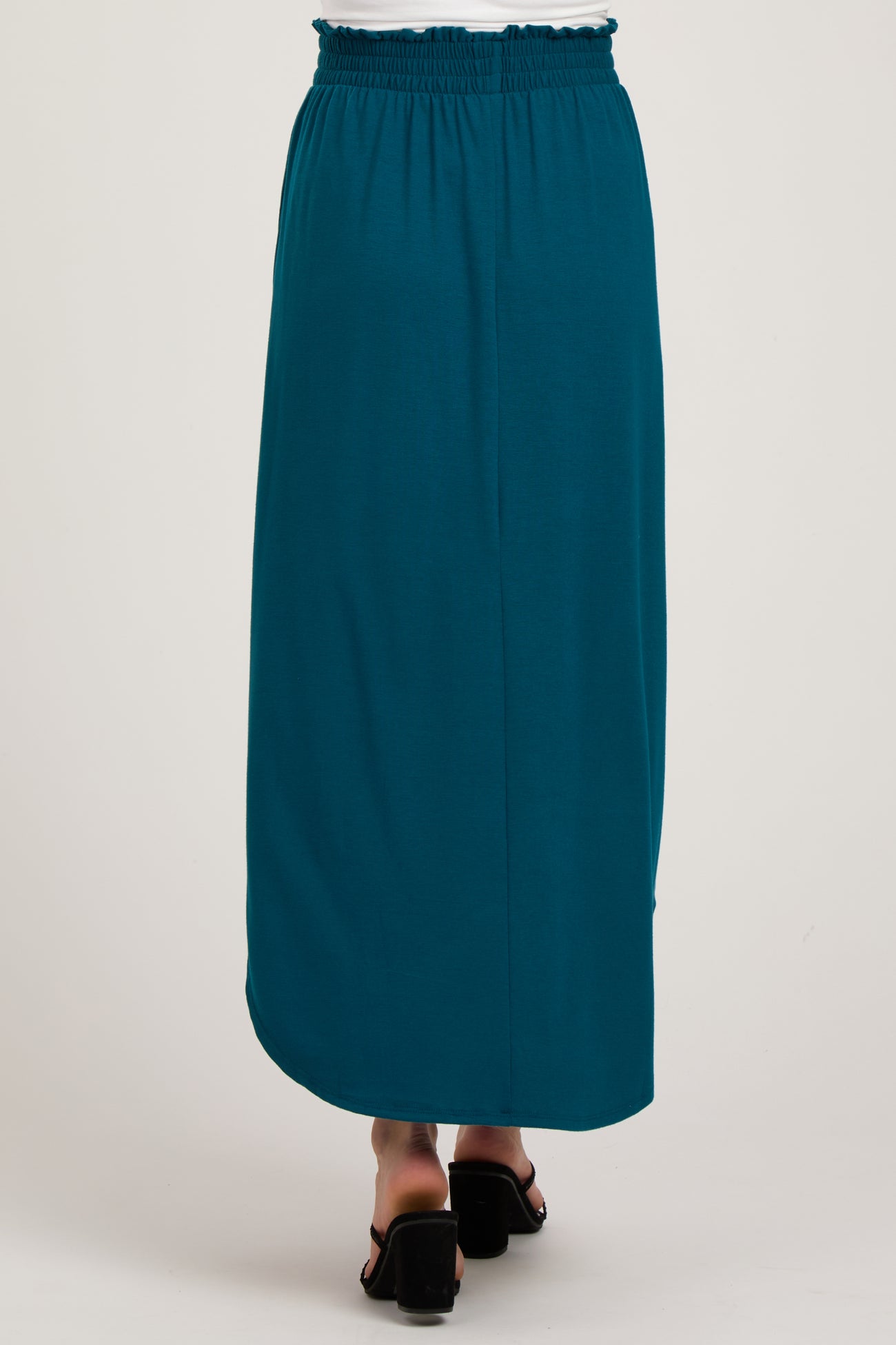 woman wearing a teal maternity maxi skirt with an elastic waistband, shown from the back