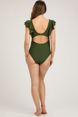 woman wearing a dark green maternity one-piece swimsuit with ruffle sleeves and a cut-out back