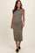 woman wearing a black and beige striped midi maternity dress with cap sleeves and a fitted silhouette, showing a baby bump