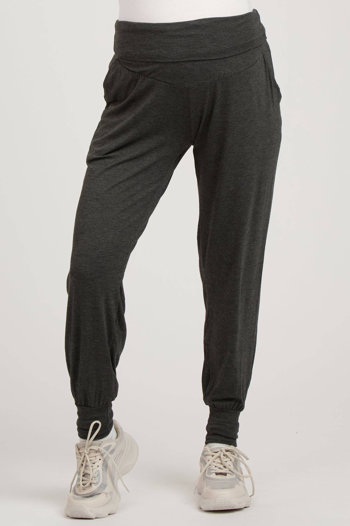 woman wearing dark gray maternity jogger pants with a wide waistband and gathered cuffs