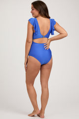 woman wearing a bright blue maternity swimsuit with ruffled sleeves and an open back