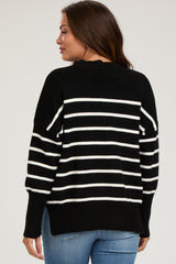 woman wearing a black and white striped maternity sweater, showing a relaxed fit and long sleeves