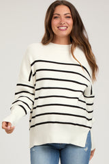 woman wearing a striped white and black maternity sweater with relaxed fit and wide sleeves