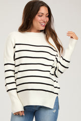 woman wearing a cream and black striped maternity sweater with side slits and relaxed fit