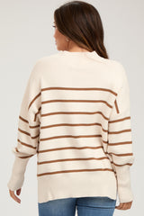 woman wearing a beige and brown striped maternity sweater, showing the back view with a relaxed fit