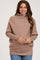 woman wearing a taupe oversized maternity sweater with a cowl neck and long sleeves